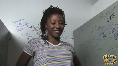 A slim Black girl sucks a white cock in a gloryhole